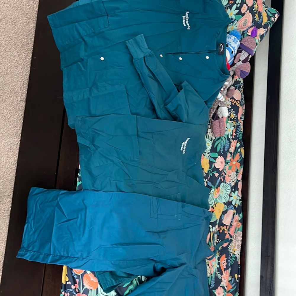 Carribean blue embroidered RN scrub jacket.